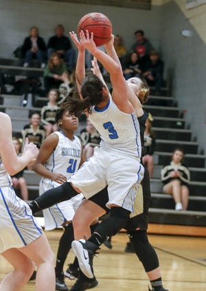 Skylar Grub of East Davidson blocks a shot attempt fro Oak Grove's Jordan Holt Thursday night during the Davidson County Christmas Classic at Ledford. [Michael Coppley for The Dispatch]