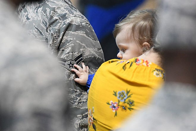 A child of a deploying Louisiana National Guard Airman traces his dad's rank during a deployment ceremony at Naval Air Station Joint Reserve Base New Orleans in Belle Chasse, Louisiana, Dec. 19, 2018. The majority of the deploying Airmen will be supporting Operation Inherent Resolve and Operation Spartan Shield in locations ranging from Qatar, Iraq, Afghanistan, Jordan, Kuwait and Germany.