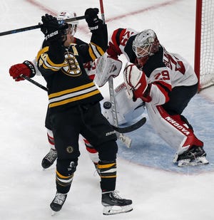 It was that kind of night for the Bruins as David Krecji (front left) is checked by the Devils' Brett Seney and New Jersey goaltender Mackenzie Blackwood (right) keeps the puck in front in the Bruins 5-2 loss to the Bruins Thursday night. [AP Photo/Elise Amendola]