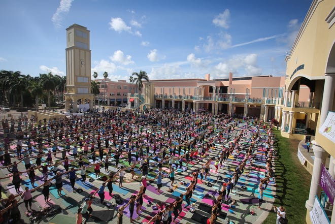 More than 1000 people practice yoga together on New Year's day 2016 at the Mizner Amphitheater. The event, spearheaded by Leslie and Andy Glickman of Yoga Journey, was designed to start the year off in a "big way" by bringing the community together in a free class taught by Leslie. Damon Higgins / The Palm Beach Post
