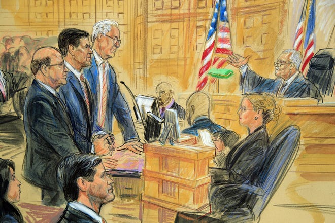 This courtroom sketch depicts former President Donald Trump’s former national security adviser Michael Flynn, standing center, flanked by his lawyers, listening to U.S. District Judge Emmet Sullivan, right, as he addresses Flynn and points to the American flag inside the federal court in Washington on Tuesday, Dec. 18, 2018. (Cameras are not always allowed in federal court.) [Dana Verkouteren via AP]