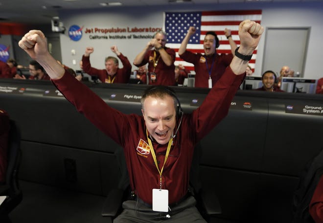 Engineer Kris Bruvold celebrates at NASA's Jet Propulsion Laboratory as the InSight lander touches down on Mars on Nov. 26. U.S. Rep. Lamar Smith says the Science Committee must meet challenges that include travel to Mars. [AP PHOTO/AL SEIB/LOS ANGELES TIMES via AP]