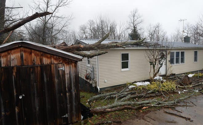 This Harborcreek Township home and shed were damaged when high winds toppled a large tree at 5760 Peck Rd. late on Thursday. Homeowner Judy Burick said damage inside was minor but that her electricity was out due to the fallen tree. [GREG WOHLFORD/ERIE TIMES-NEWS]