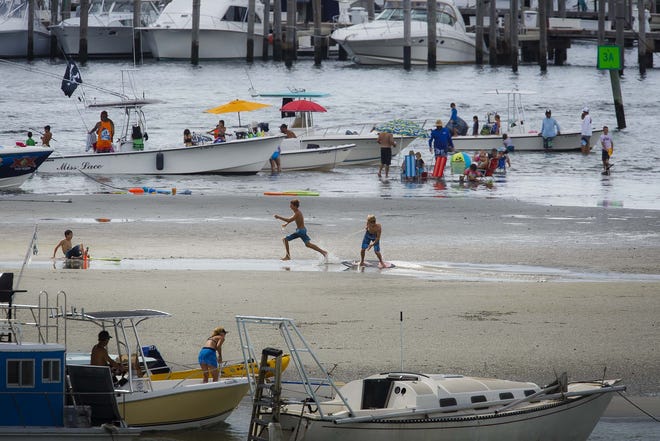 Boys play on a skimboard on a sandbar near Phil Foster Park and Peanut Island in Riviera Beach, Fla., on Monday, September 7, 2015. The Florida Department of Health on Friday, Dec. 28, 2018, issued a no-swimming advisory at the Intracoastal Waterway park after high levels of bacteria were found in nearby waters. [Thomas Cordy/palmbeachpost.com]