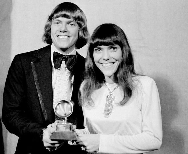 Richard and Karen Carpenters, of The Carpenters, pose with their Grammy on March 17, 1971, during the 13th annual 1970 Grammy Awards in Los Angeles. The brother-sister duo was named best new artist of the year, 1970, and also won as the best contemporary duo or group vocalists for "Close to You." [THE ASSOCIATED PRESS/FILE]