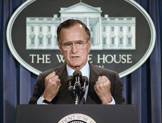 President George H.W. Bush holds a news conference at the White House in Washington in 1989. Bush died at the age of 94 on Nov. 30, about eight months after the death of his wife, Barbara Bush. [AP Photo/Marcy Nighswander, File]