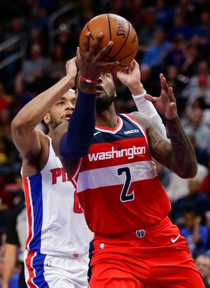 Washington Wizards guard John Wall (2) goes to the basket past Detroit Pistons guard Bruce Brown during the second half of an NBA basketball game Wednesday, Dec. 26, 2018, in Detroit. The Pistons defeated the Wizards 106-95. (AP Photo/Duane Burleson)