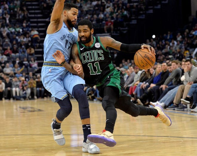 Kyrie Irving of the Celtics drives on Garrett Temple of Memphis during the second half on Saturday night.