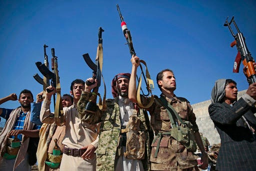 FILE - In this Dec. 13, 2018, file, photo, tribesmen loyal to Houthi rebels hold up their weapons as they attend a gathering to show their support for the ongoing peace talks being held in Sweden, in Sanaa, Yemen. The United Nations has cast doubt on the claims by Yemen’s Shiite rebels to have withdrawn from the port of Hodeida, saying such steps can only be credible if all other parties can verify them.(AP Photo/Hani Mohammed, File)
