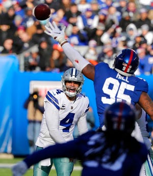 Dallas Cowboys quarterback Dak Prescott, left, throws during the first half of an NFL football game against the New York Giants, Sunday, Dec. 30, 2018, in East Rutherford, N.J. (AP Photo/Frank Franklin II)