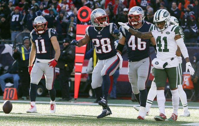Patriots running back James White (28) does a celebration dance after scoring a touchdown during the first quarter of Sunday's game against the Jets.