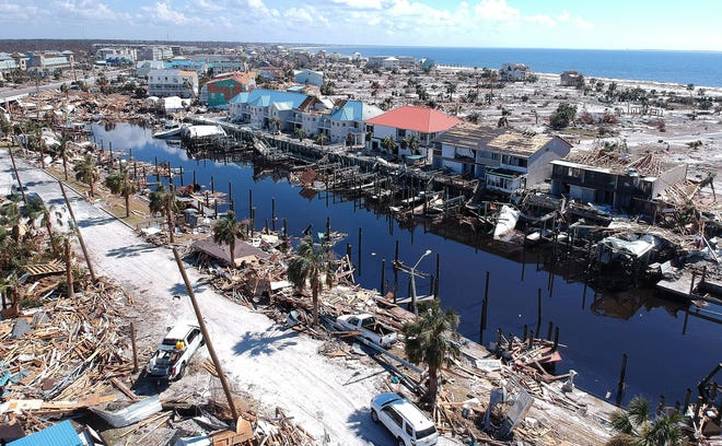 Homes, water craft and debris littered a canal in Mexico Beach, FL. As first responders searched for missing people, some residents of Panama City and returned back their homes Monday October 15, 2018 to see what was left after Hurricane Michael, a category 4 hurricane, struck the panhandle last Wednesday. [Doug Engle/Ocala Star Banner]2018