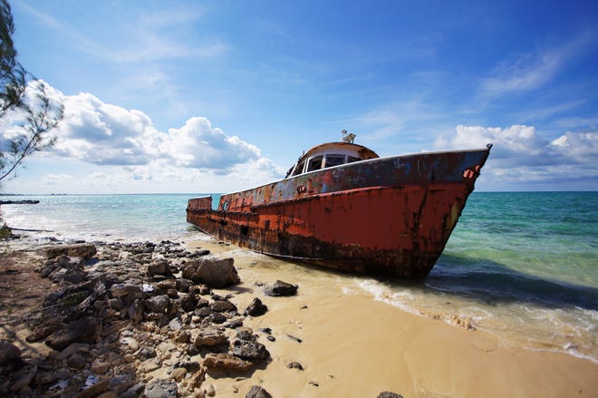 A corroding fishing boat, abandoned after its captain passed away, on a beach in Exuma Sound on Cat Island, Bahamas. [Contributed by John Briley for The Washington Post]