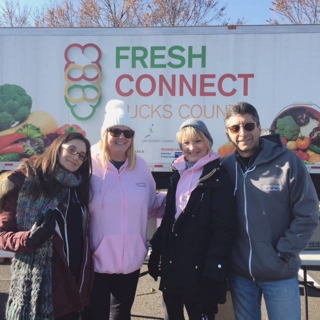 Mr. D's Tees of Warminster participated in its annual give back to the community event by volunteering with Fresh Connect, run by the Bucks County Opportunity Council. Mr. D's Tees helped set up and distribute produce, among other tasks, at the mobile market for those in need. From lef: Mr. D's Tees employees Meredith Matarese, Tricia Steigerwalt, Cindy Hunn and Kenn Dranoff. [COURTESY MR. D'S TEES]