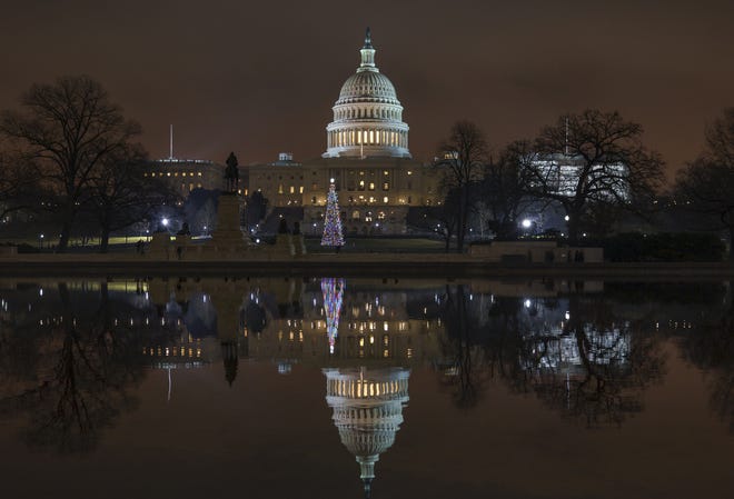 The Capitol is mirrored in the Reflecting Pool in Washington, as a partial government shutdown heads into a second week on Friday. [AP Photo/J. Scott Applewhite]