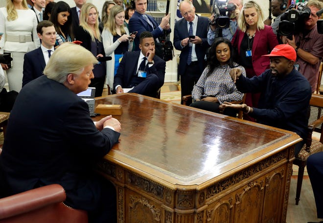 Rapper Kanye West speaks to President Donald Trump and others in the Oval Office of the White House in Washington on Oct. 11, 2018. [Evan Vucci, Associated Press file]