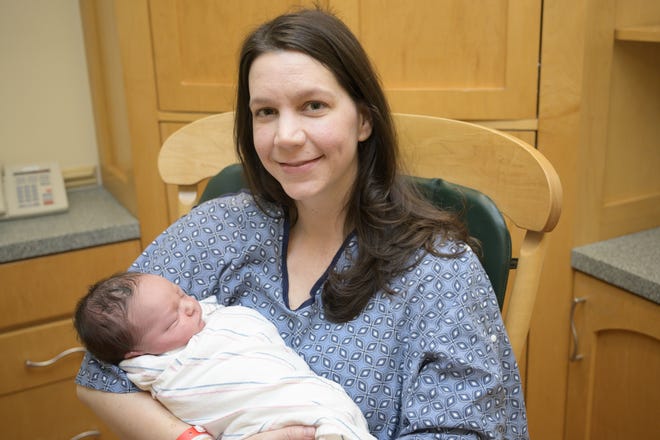 Jessica Whitler holds her new baby boy, Eli Nolan, born at 1:47 a.m. on New Year's Day at Leesburg Regional Medical Center. [Cindy Sharp/Correspondent]