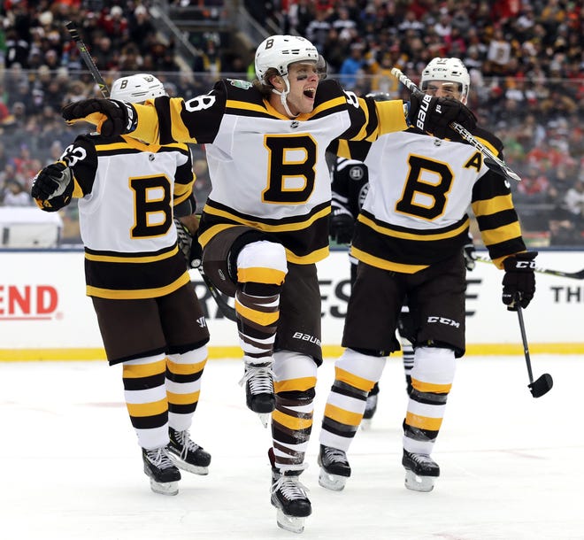 David Pastrnak (center) celebrates after scoring a goal against the Chicago Blackhawks in the first period of the NHL Winter Classic hockey game at Notre Dame Stadium on Tuesday in South Bend, Ind. [AP Photo/Nam Y. Huh]