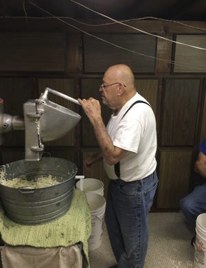 SUBMITTED PHOTO

Spike Antonelli operates the device that shreds the cabbage.