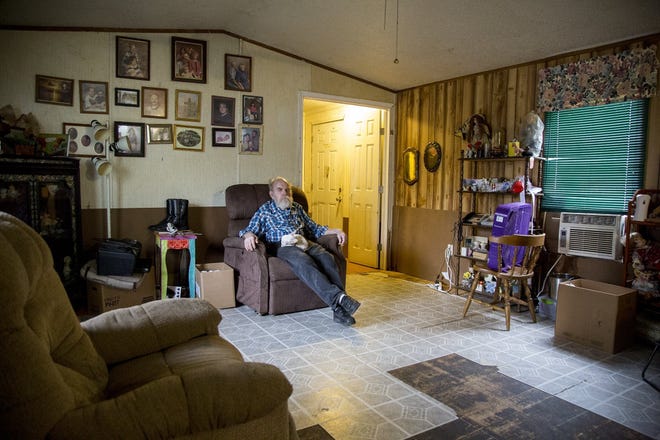 Charles Simpson, 77, sits in a recliner while his chihuahua naps on him. The floor of his house is a hodgepodge of flooring left from the flood or tried to be replaced after the flood. [ANA RAMIREZ/AMERICAN-STATESMAN]