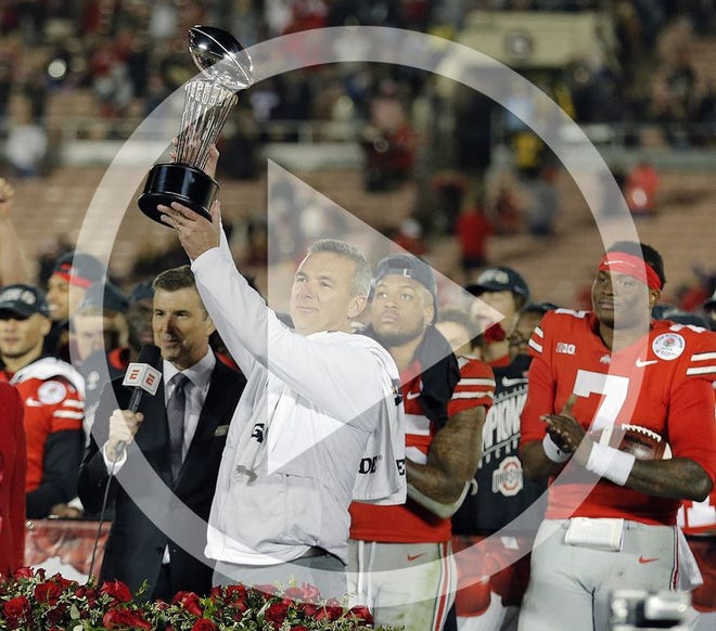 Ohio State Buckeyes head coach Urban Meyer holds up the Leishman Trophy after beating Washington Huskies 28-23 in the 105th Rose Bowl in Pasadena, California on January 1, 2019.