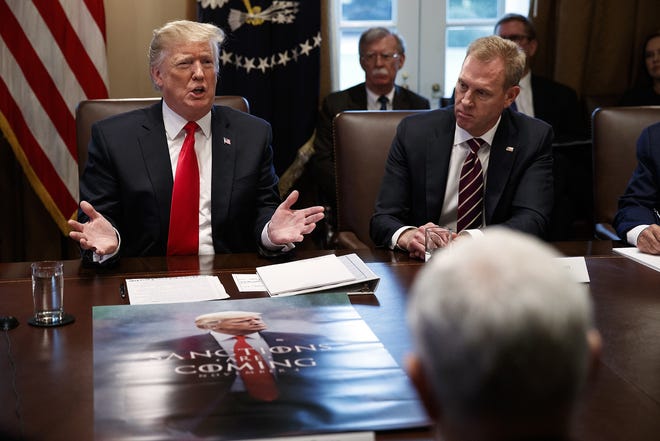 Acting Secretary of Defense Patrick Shanahan, right, listens as President Donald Trump speaks during a cabinet meeting at the White House Wednesday in Washington. [EVAN VUCCI/ASSOCIATED PRESS]