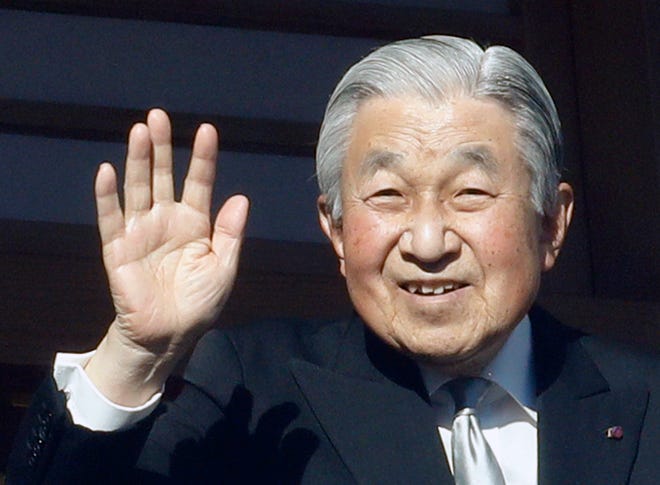 Japan's Emperor Akihito waves to well-wishers from the bullet-proofed balcony during his New Year's public appearance with his family members at Imperial Palace in Tokyo Wednesday, Jan. 2, 2019. (AP Photo/Eugene Hoshiko)