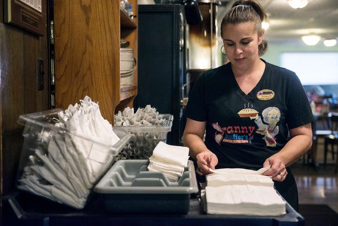 Shawna Green, a server at Granny Shaffer’s, prepares utensils for customers at the restaurant in Joplin, Mo. Wages will be increasing for millions of low-income workers across the U.S. as the new year ushers in new laws in numerous states. [ROGER NOMER/THE JOPLIN GLOBE]