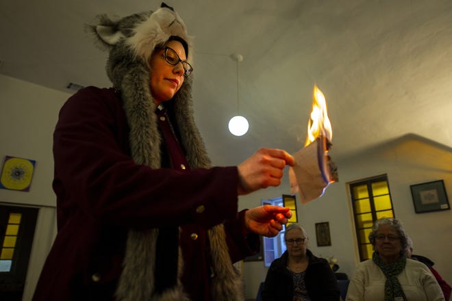 Mary Lipinski burns a piece of paper containing things she wishes to leave behind in the new year during the Burning Bowl Ceremony at the Center for Inner Peace on New Year's Eve.

[CHIEFTAIN PHOTO/STEPHEN SWOFFORD]