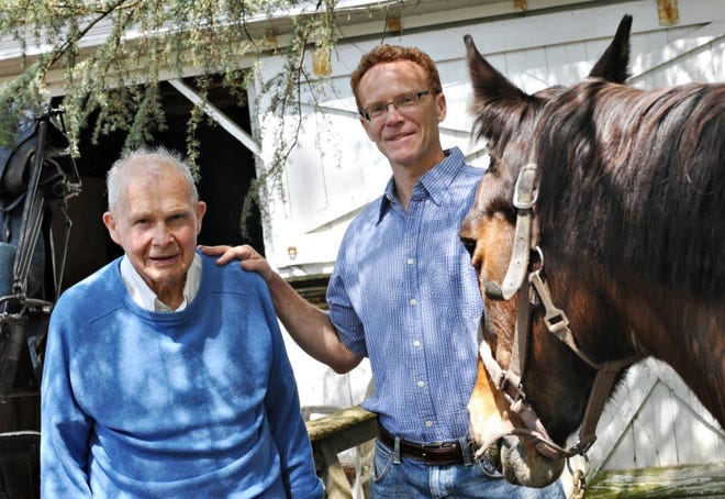 Samuel Snipes, left, and son Jonathan, along with the Snipes' horse Persimmon, pose at Snipes Farm in Falls in 2012. [Archive photo]