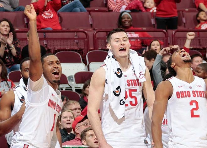 From left, Ohio State Buckeyes guard Luther Muhammad (1), Ohio State Buckeyes forward Kyle Young (25) and Ohio State Buckeyes guard Musa Jallow (2) celebrate after a dunk from Ohio State Buckeyes forward Justin Ahrens, not pictured, during the second half of a NCAA men's basketball game between the Ohio State Buckeyes and the South Carolina State Bulldogs on Nov. 18 at Value City Arena. The Buckeyes defeated the Bulldogs, 89-61. [Joshua A. Bickel]