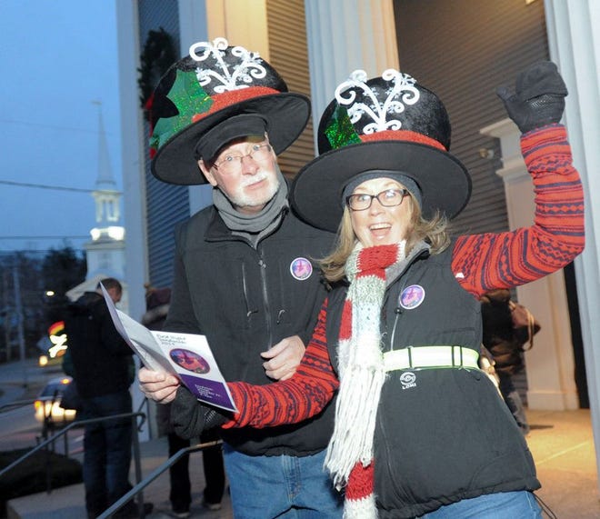 Paula Keenan and Steven Good of Falmouth get in the spirit just after getting their buttons in front of Sandwich town hall for first night.
