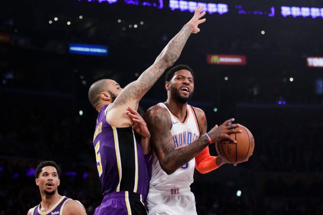 Oklahoma City Thunder's Paul George, right, is defended by Los Angeles Lakers' Tyson Chandler during the first half of an NBA basketball game, Wednesday, Jan. 2, 2019, in Los Angeles. (AP Photo/Jae C. Hong)