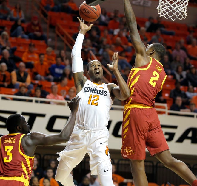 Oklahoma State's Cameron McGriff (12) goes to the basket between Iowa State's Marial Shayok (3) and Cameron Lard (2) during an NCAA basketball game between the Oklahoma State Cowboys (OSU) and the Iowa State Cyclones at Gallagher-Iba Arena in Stillwater, Okla. Wednesday, Jan. 2, 2019. Photo by Bryan Terry, The Oklahoman