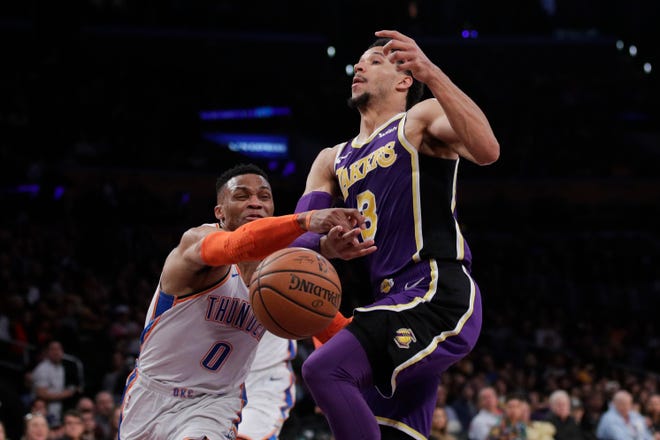 Russell Westbrook swipes the ball away from Josh Hart during the Thunder's 107-100 win at the Lakers on Wednesday. [AP PHOTO]