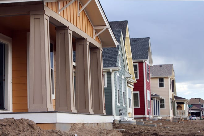 A row of single-family homes under construction stands in a redevelopment project. [AP Photo/David Zalubowski, File]