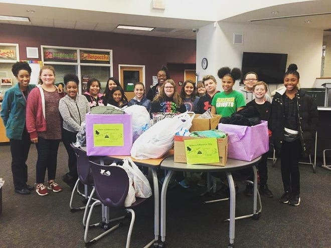 Pictured are students from Grier Middle School with some of the items they collected. [PHOTO COURTESY OF CARLY CALDWELL]