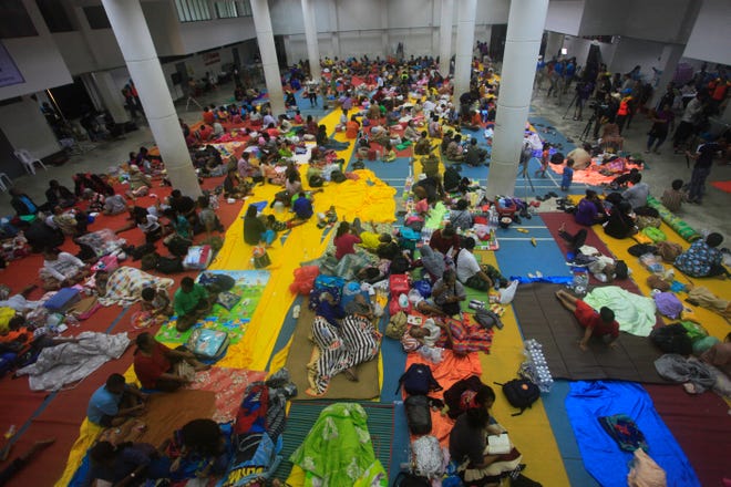 Thai people sleep at an evacuation center in Nakhon Si Thammarat province, Thailand, Thursday, Jan. 3, 2019. Thai weather authorities are warning that a tropical storm will bring heavy rain and high seas to southern Thailand and its famed beach resorts. (AP Photo/Sumeth Panpetch)
