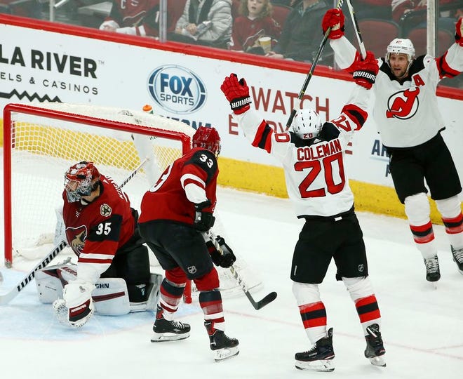 New Jersey Devils center Blake Coleman (20) celebrates his goal with Devils center Travis Zajac, right, as Arizona Coyotes goaltender Darcy Kuemper (35) and defenseman Alex Goligoski (33) look for the puck during the second period of an NHL hockey game Friday, Jan. 4, 2019, in Glendale, Ariz. (AP Photo/Ross D. Franklin)