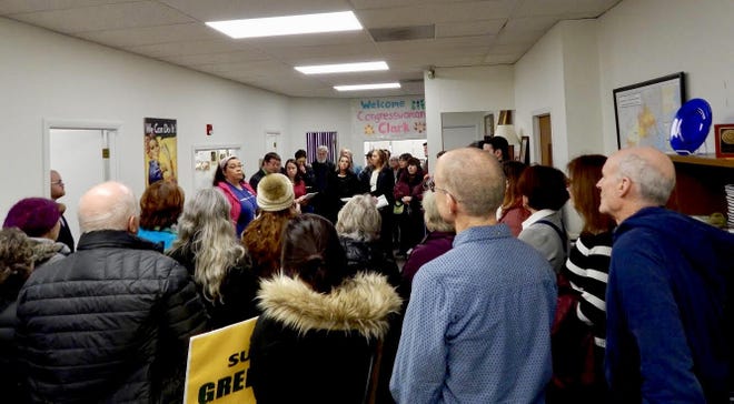 Members of several Indivisible groups, among others, crowd into Congresswoman Katherine Clark's Cambridge office to rally for democracy, climate, and immigration reform. [Wicked Local photo / Julia Taliesin]