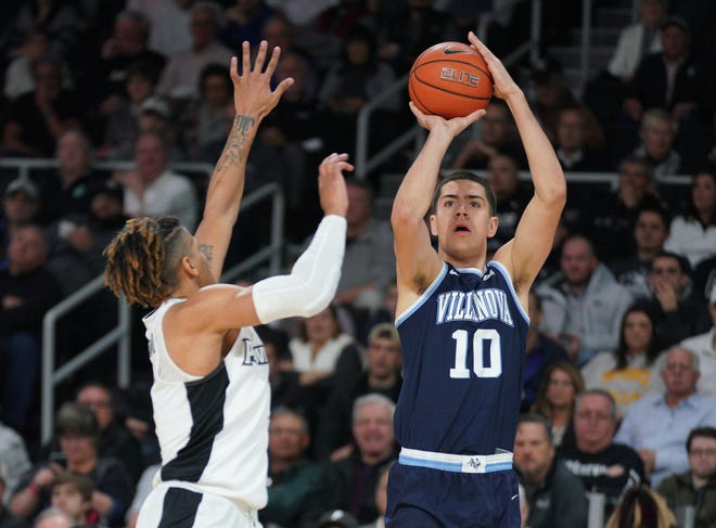 Villanova freshman guard Cole Swider shoots over Providence defender Makai Ashton-Langford during Saturday's game at the Dunkin' Donuts Center. Swider, a Portsmouth resident, finished with 10 points in the Wildcats' 65-59 victory. [LOUIS WALKER III PHOTOGRAPHY]