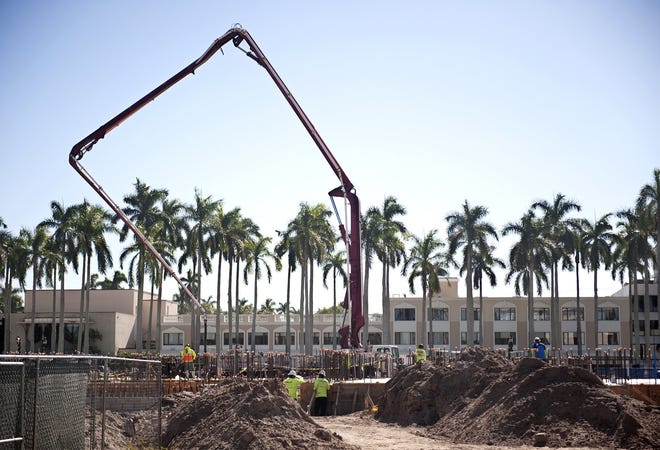 More than 40 trucks brought in 340 cubic yards of cement Dec. 18 to be poured for a building slab as Hedrick Brothers Construction continues work on the new Palm Beach Recreation Center between Royal Palm Way and Seaview Avenue. [Meghan McCarthy/palmbeachdailynews.com]
