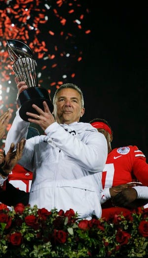 Ohio State Buckeyes head coach Urban Meyer raises the Leishman Trophy following the Buckeyes' 28-23 victory against the Washington Huskies in the 105th Rose Bowl Game on Tuesday, January 1, 2019 at the Rose Bowl in Pasadena, California. [Joshua A. Bickel]