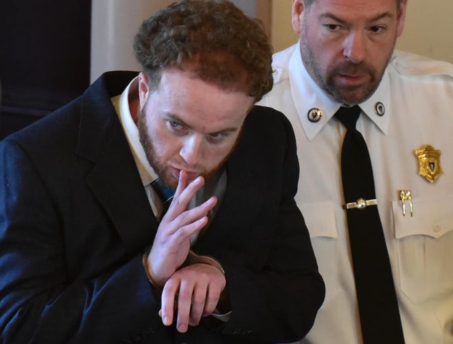 Accused murderer Thomas Latanowich gestures to family members as he is brought into Barnstable Superior Court on Friday morning for a pre-trial hearing. 

[Steve Heaslip/Cape Cod Times]