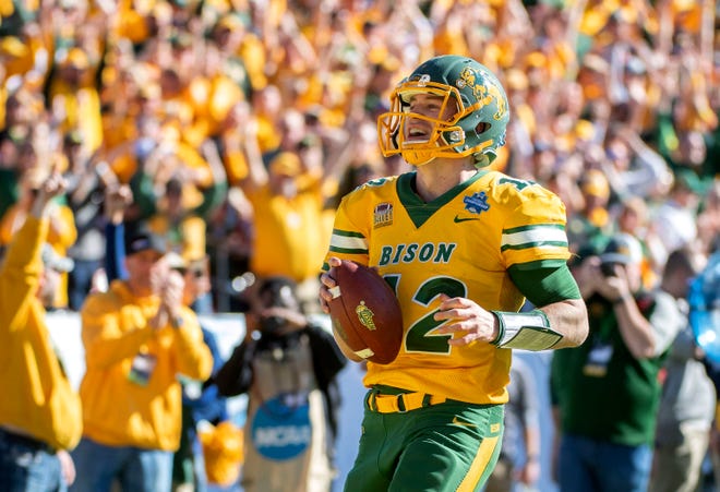North Dakota State quarterback Easton Stick smiles as he scores against Eastern Washington during the second half of the FCS championship game on Saturday in Frisco, Texas. [AP PHOTO]