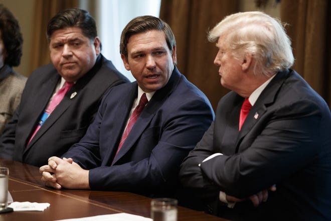 Governor-elect Ron DeSantis talks with President Donald Trump during a December meeting with newly elected governors in the Cabinet Room of the White House. DeSantis is set to be sworn in Tuesday. [FILE/THE ASSOCIATED PRESS]