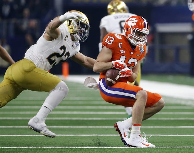 Notre Dame linebacker Drue Tranquill (23) prepares to wrap up Clemson wide receiver Hunter Renfrow (13) after a catch in the first half of the Cotton Bowl semifinal playoff game Dec. 29, 2018 in Arlington, Texas. [MICHAEL AINSWORTH/THE ASSOCIATED PRESS]