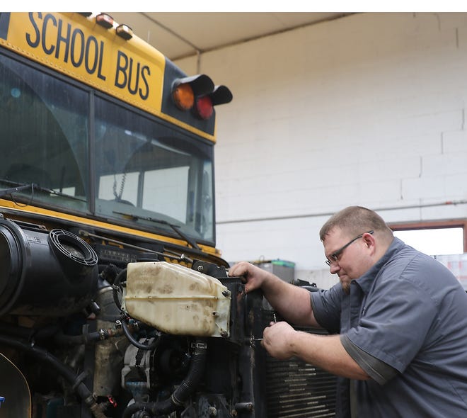 January Difference Maker James Katicich works on a school bus at the Indian Valley bus garage. (TimesReporter.com / Jim Cummings)