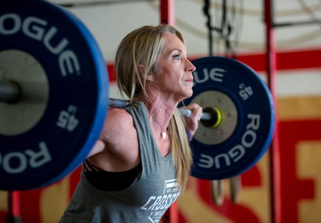 Julie Dudley, who turns 51 today, a grandmother and firefighter from Jupiter, works out at CrossFit Wild in West Palm Beach on Friday. She recently competed in NBC's "The Titan Games," hosted by Dwayne "The Rock" Johnson. [RICHARD GRAULICH/GATEHOUSE FLORIDA]