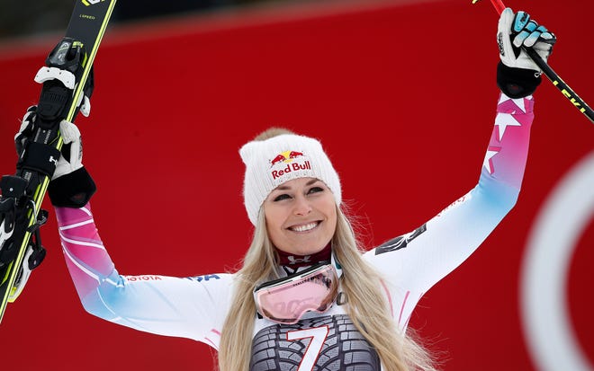 FILE - In this Feb. 4, 2018, file photo, United States' Lindsey Vonn celebrates on the podium after winning an alpine ski, women's world Cup downhill race, in Garmisch Partenkirchen, Germany. Lindsey Vonn is planning to return from injury this weekend, Jan. 12-13, 2019, for speed races in Austria, resuming her quest for the all-time record for World Cup wins. (AP Photo/Gabriele Facciotti, File)